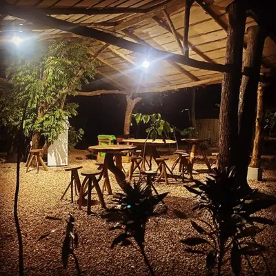 a picnic table under a pavilion at night with lights at Finca Avellanas in Playa Avellana