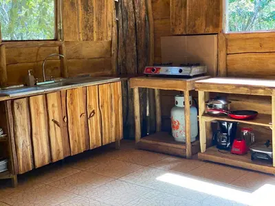a kitchen with wooden cabinets and a sink at Finca Avellanas in Playa Avellana