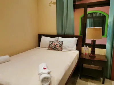 a bedroom with a bed with a hat on it at One Bedroom Villa on 20 Acres of Nature! 