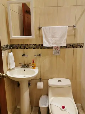a small bathroom with a toilet and a sink at One Bedroom Villa on 20 Acres of Nature! 