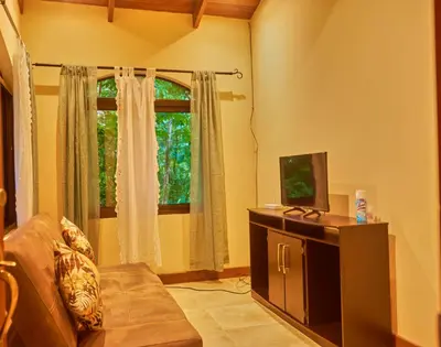 a living room with a couch and a window at One Bedroom Villa on 20 Acres of Nature! 