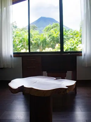 a room with a table in front of a window at Termales del Arenal in Fortuna
