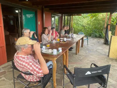 a group of people sitting at a wooden table at Birds & Breakfast Costa Rica in Fortuna