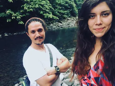 a man and a woman standing next to a river at Birds & Breakfast Costa Rica in Fortuna