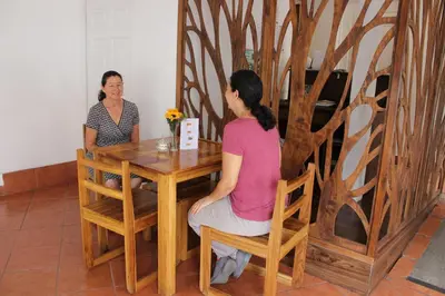 two women sitting at a table in a room at Park View Hotel & Restaurant in Alajuela City