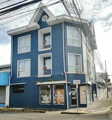 a blue building on the corner of a street at Park View Hotel & Restaurant in Alajuela City