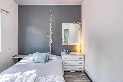 a bedroom with a bed and a mirror and a dresser at Casa Conchas in Carrillo