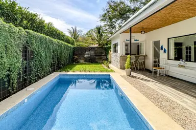 a swimming pool in the backyard of a house at Casa Conchas in Carrillo