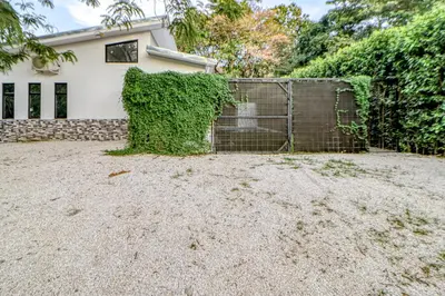 a fence in front of a house at Casa Conchas in Carrillo