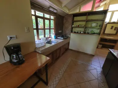 a kitchen with a sink and a counter top at Cabina Rancho la Merced in Uvita