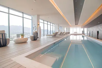 a swimming pool in a building with windows at Hilton San Jose La Sabana in San José