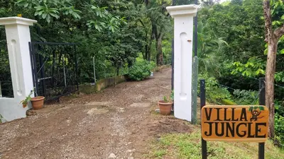a sign that reads villa jungle next to a gate at Villas jungle 5 in Sámara