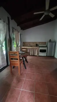 a living room with a table and a kitchen at Villas jungle 5 in Sámara