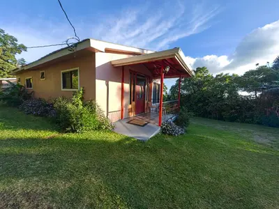 a small house with a porch in a yard at Monteverde House in Monteverde Costa Rica