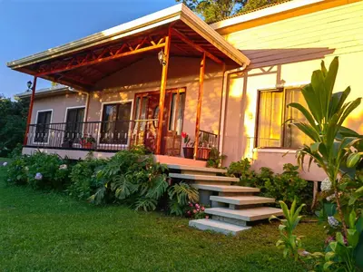 a house with stairs leading to a porch at Monteverde House in Monteverde Costa Rica