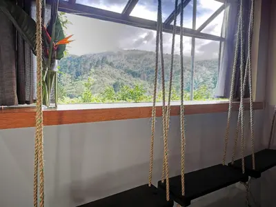 a window with a view of a mountain at Cabaña Hamacas in Cartago