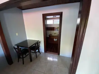a dining room with a table and a mirror at Hotel Puerto San Luis in Tilarán