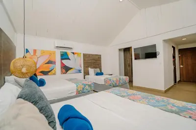 a hotel room with two beds and a tv at Ocotal Beach House in Sardinal