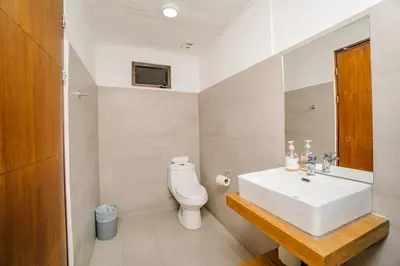 a bathroom with a white sink and a toilet at Ocotal Beach House in Sardinal