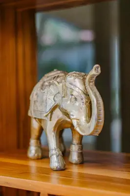a wooden elephant figurine sitting on a table at Ocotal Beach House in Sardinal