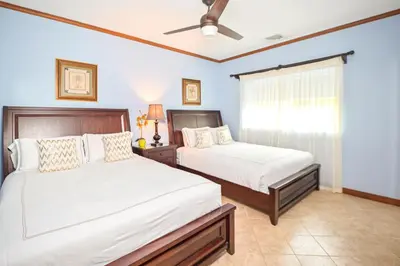 a bedroom with two beds and a window at Veranda 1H 3 bdr Garden View in Los Suenos in Herradura