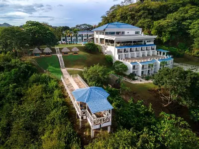 an aerial view of a building with a blue umbrella at Dunama Ocean View Hotel in Playa Flamingo