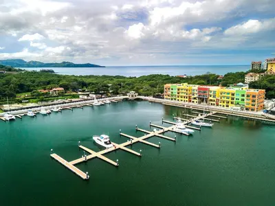 a group of boats docked at a dock in the water at Dunama Ocean View Hotel in Playa Flamingo
