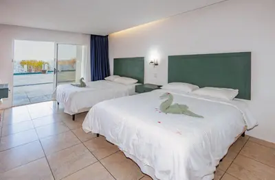 a hotel room with two beds with birds on them at Dunama Ocean View Hotel in Playa Flamingo