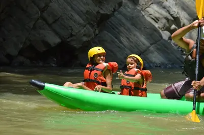 two children in a kayak on a river at Jungle Beach Hotel Manuel Antonio in Manuel Antonio