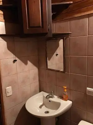 a bathroom with a sink and a mirror at FLOR DE PARAISO BUNGALOWS in Montezuma