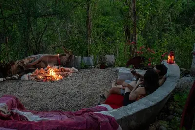 a group of people sitting around a fire pit at Marbella Retreats Casa Roja in Santa Cruz