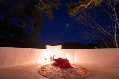 a person laying on a rug in front of a wall at night at Marbella Retreats Casa Roja in Santa Cruz