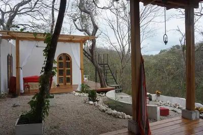 a small house with a deck and a staircase at Marbella Retreats Casa Roja in Santa Cruz