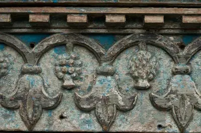 a close up of a metal wall with flowers on it at Hacienda La Isla Lodge in Sarapiquí