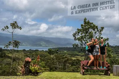 a group of people standing on top of a tree stump at Hotel La Choza Inn in Fortuna