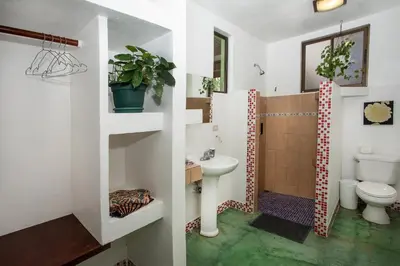 a bathroom with a toilet and a sink at Villas Jacquelina in Quepos