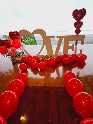 a table with a heart made out of red balloons at Vista Ballena in Uvita