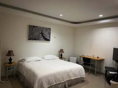 a bedroom with a bed and a desk and a television at Legacy Boutique Hotel in Quesada