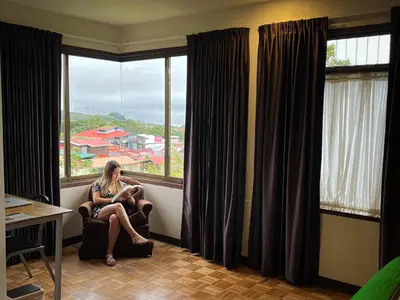 a woman sitting in a chair looking out of a window at Legacy Boutique Hotel in Quesada