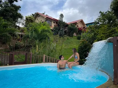 a man and a woman sitting in a swimming pool at Legacy Boutique Hotel in Quesada