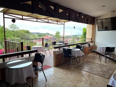a restaurant with tables and chairs on a balcony at Legacy Boutique Hotel in Quesada