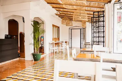 a dining room with white chairs and a table at Hotel Luz de Luna in San José