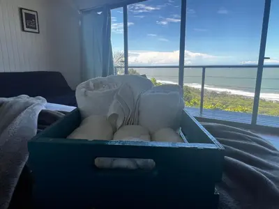a box of eggs sitting on a bed with a view of the ocean at Ranchos Remo Lodge in Uvita