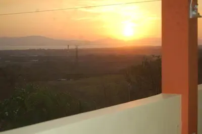 a sunset view from the window of a house at Villa Alta Bed&Breakfast in Barranca