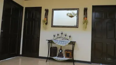 a room with two doors and a table with candles at Villa Alta Bed&Breakfast in Barranca