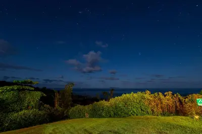 a sign on a hill at night with the stars at Punta Marenco Lodge in Drake