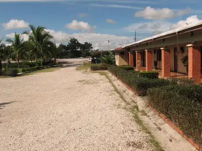 an empty road in front of a building at Hotel La Arena in Liberia
