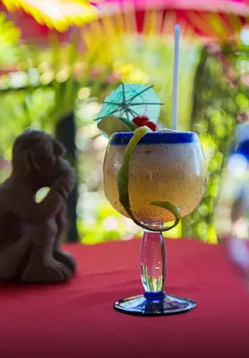 a wine glass with a fruit in it on a table at Conchal Hotel in Brasilito