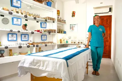a woman standing next to a bed in a room at Conchal Hotel in Brasilito