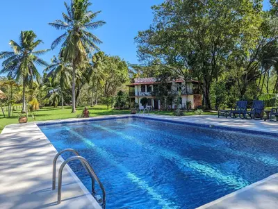 an image of a swimming pool in front of a house at spirit of jungle lodge in Sámara